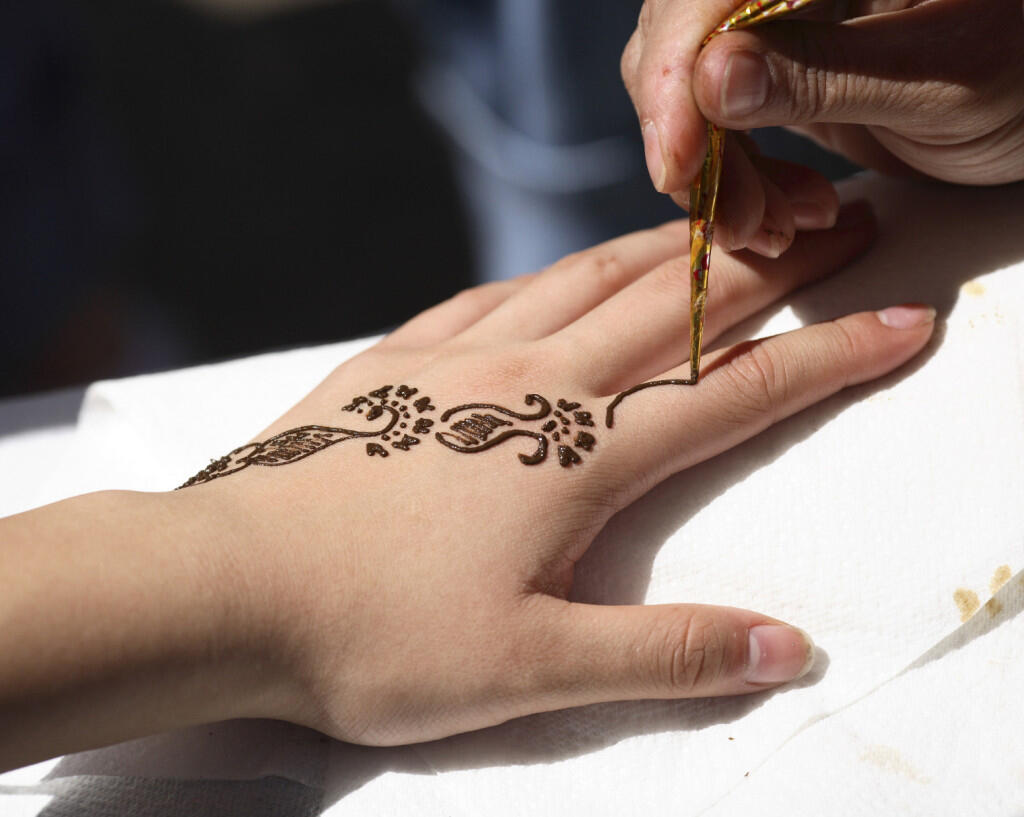 Detailed henna design on a guest’s hand